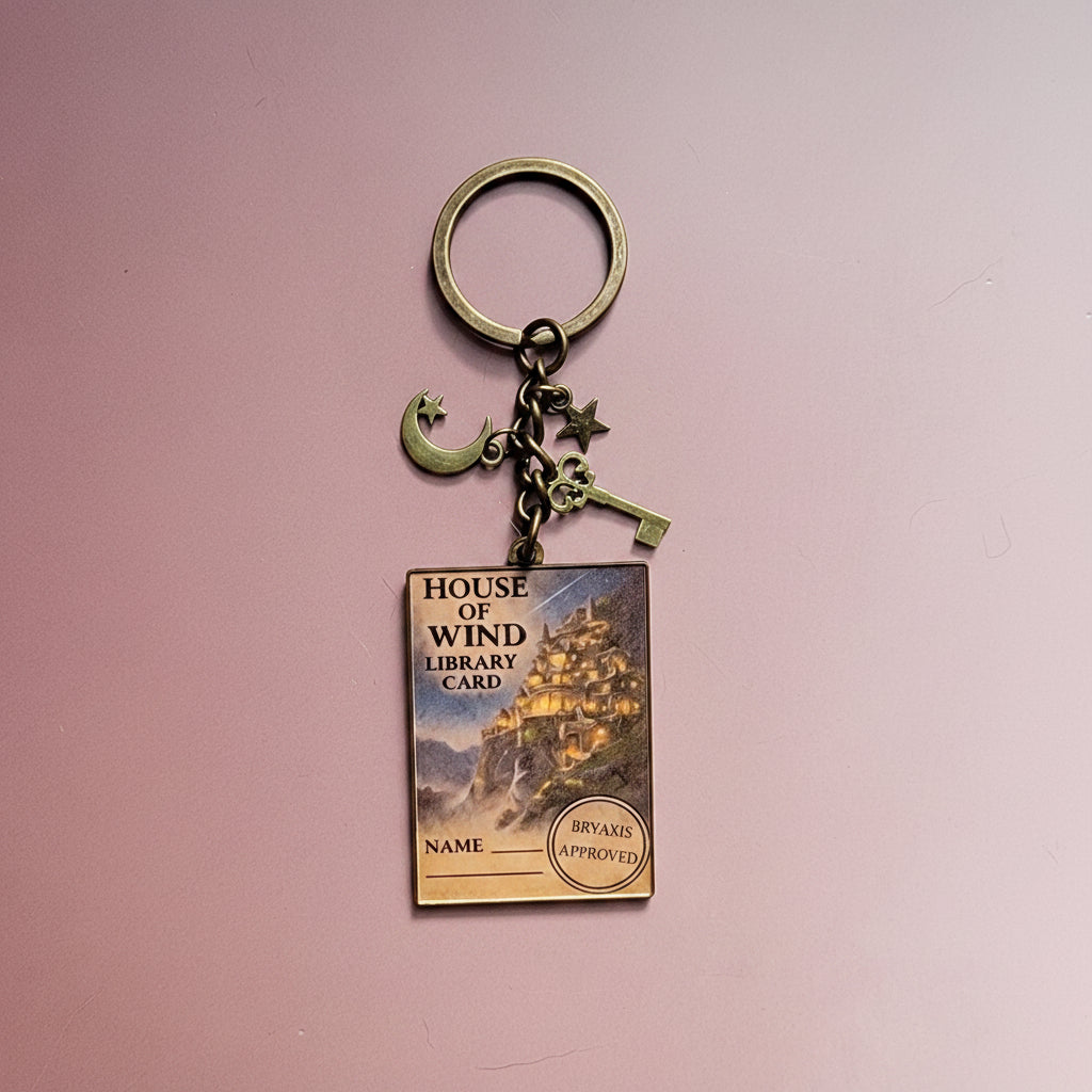 Keychain with book-themed design on a pink background
