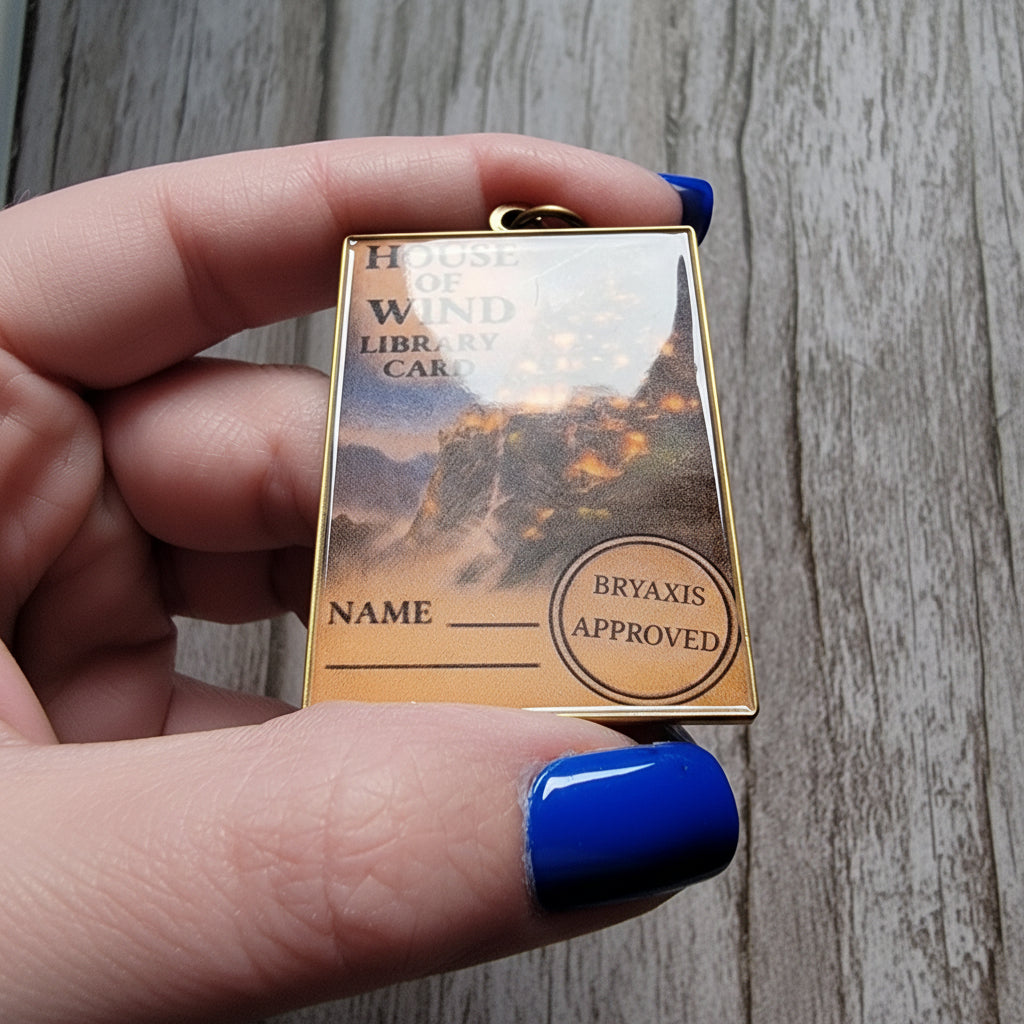 ACOTAR inspired keychain on a wood surface with a high reflective surface. 