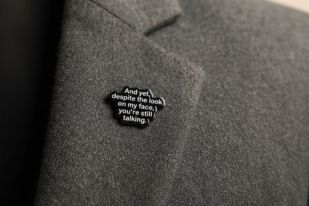 Black and white text pin on a gray fabric background