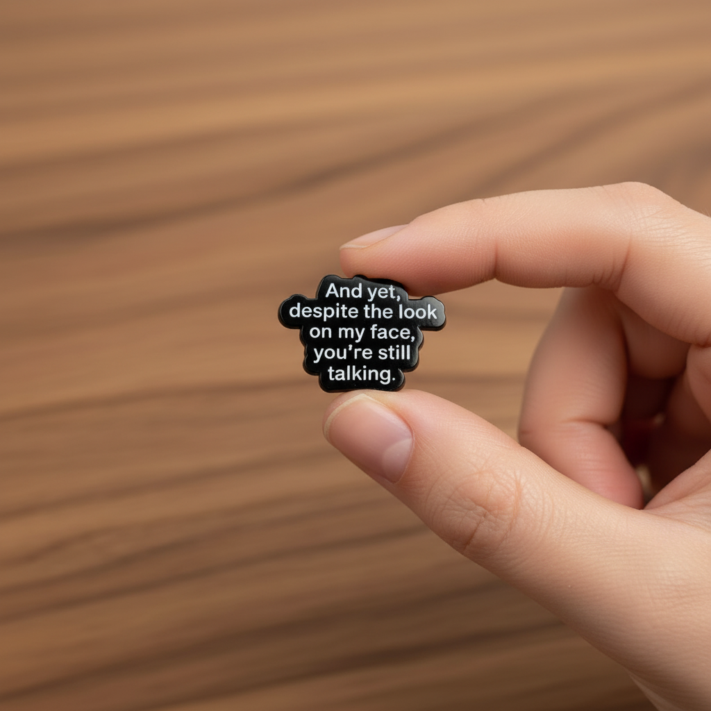 And yet despite the look on my face enamel pin on wood background sassy enamel pin with black and white text detail
