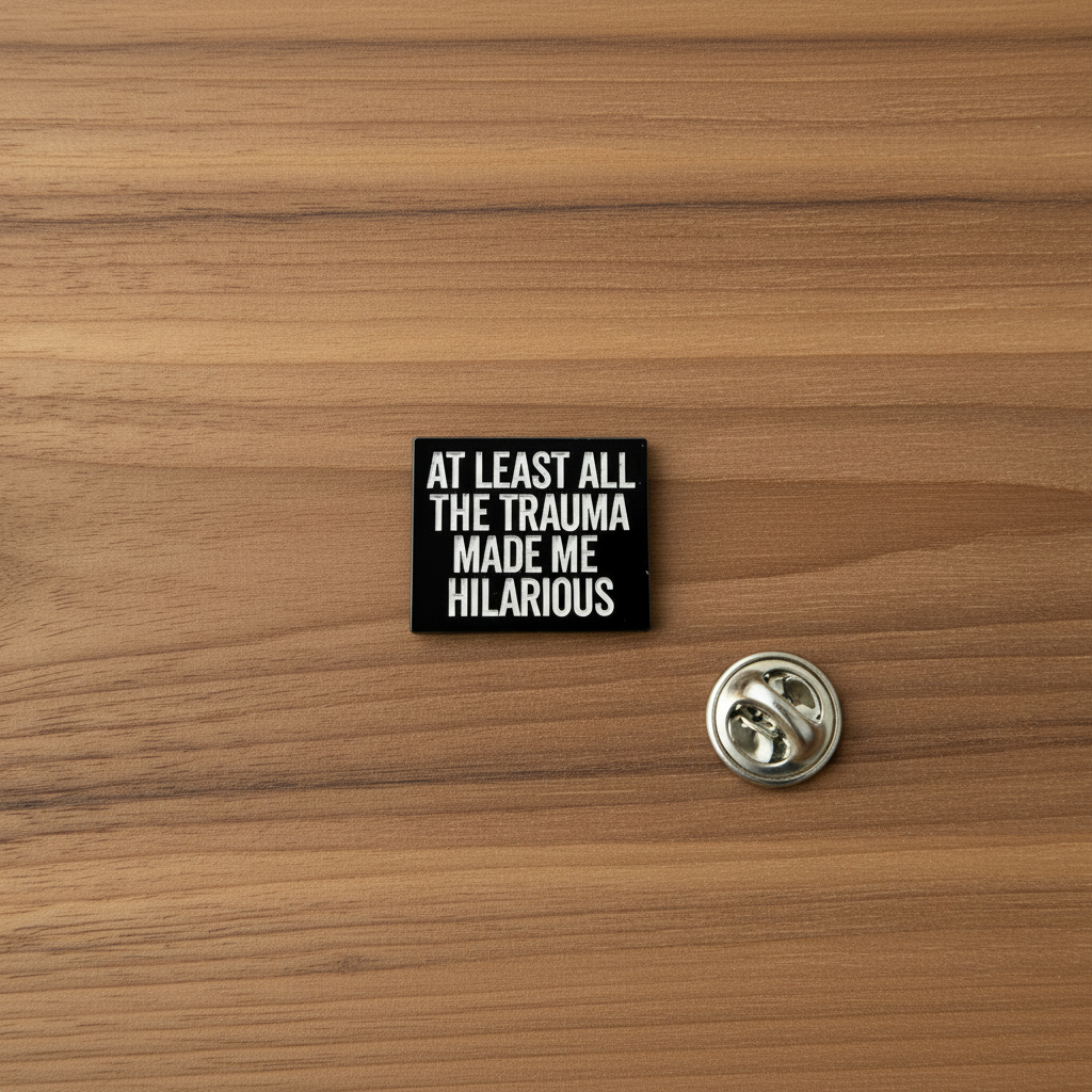 At least all this trauma made me hilarious enamel pin on wood backgroundfunny enamel pin with black and white text detail