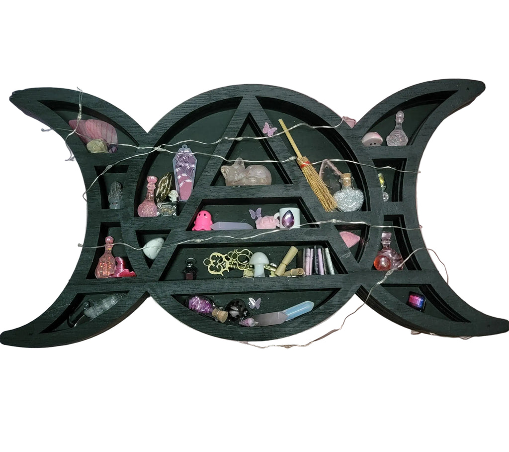Witchy shelf with various decorative items against a pink and white striped background