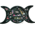 Witchy shelf with various decorative items against a pink and white striped background