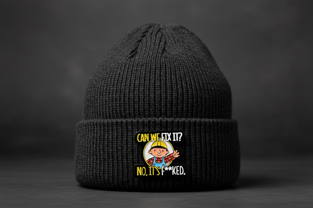 Pin with cartoon character and text on a black beanie background