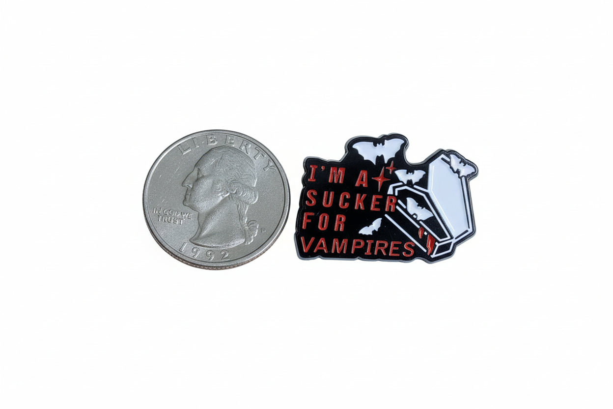 I'm a sucker for vampires enamel pin shown next to quarter for size reference Halloween enamel pin dims1 3/8 inches W x 1 inch H