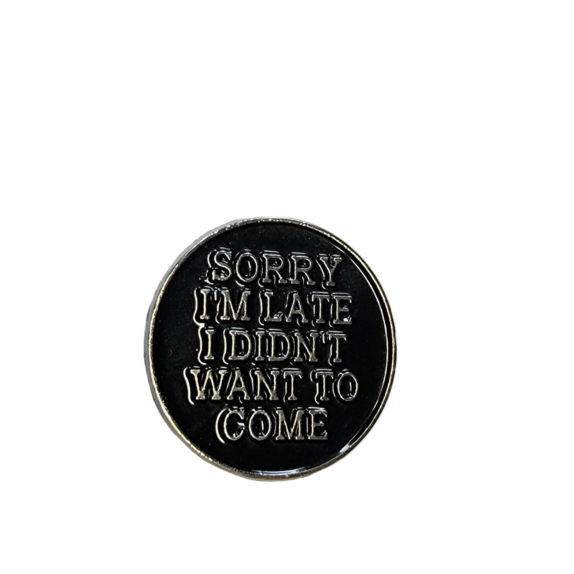 Round black metal badge with silver text on a white background