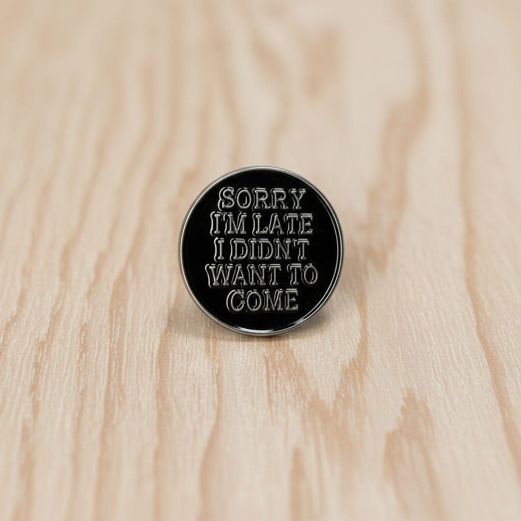 Sorry i'm late I didn't want to come enamel pin on wood background sassy enamel pin with silver text detail