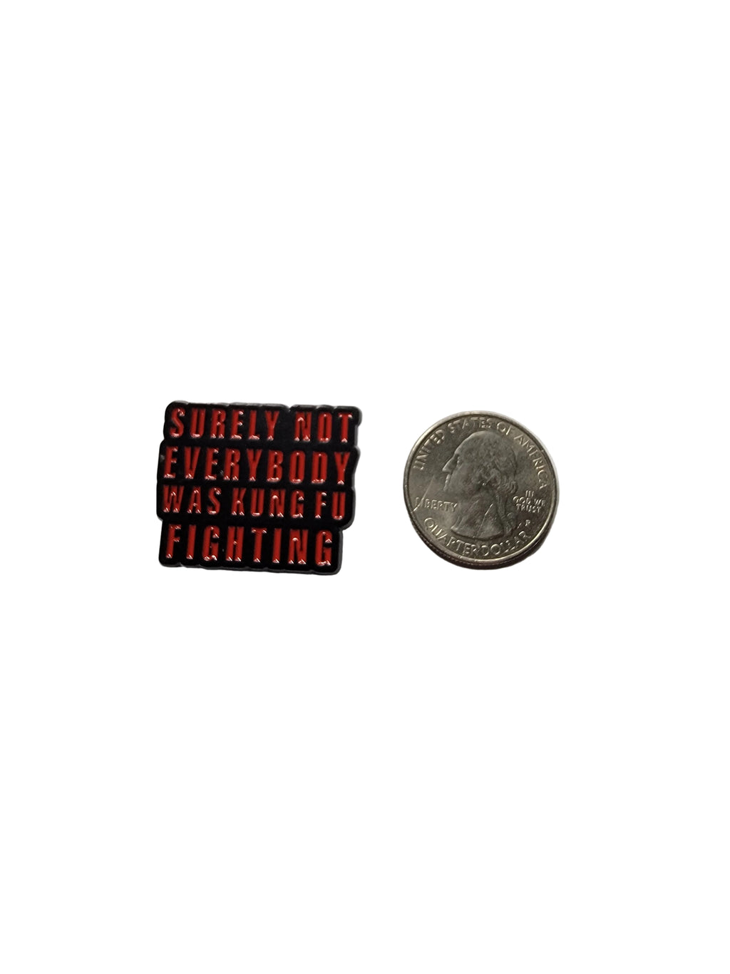 Small red and black rectangular object with text next to a coin on a gray background