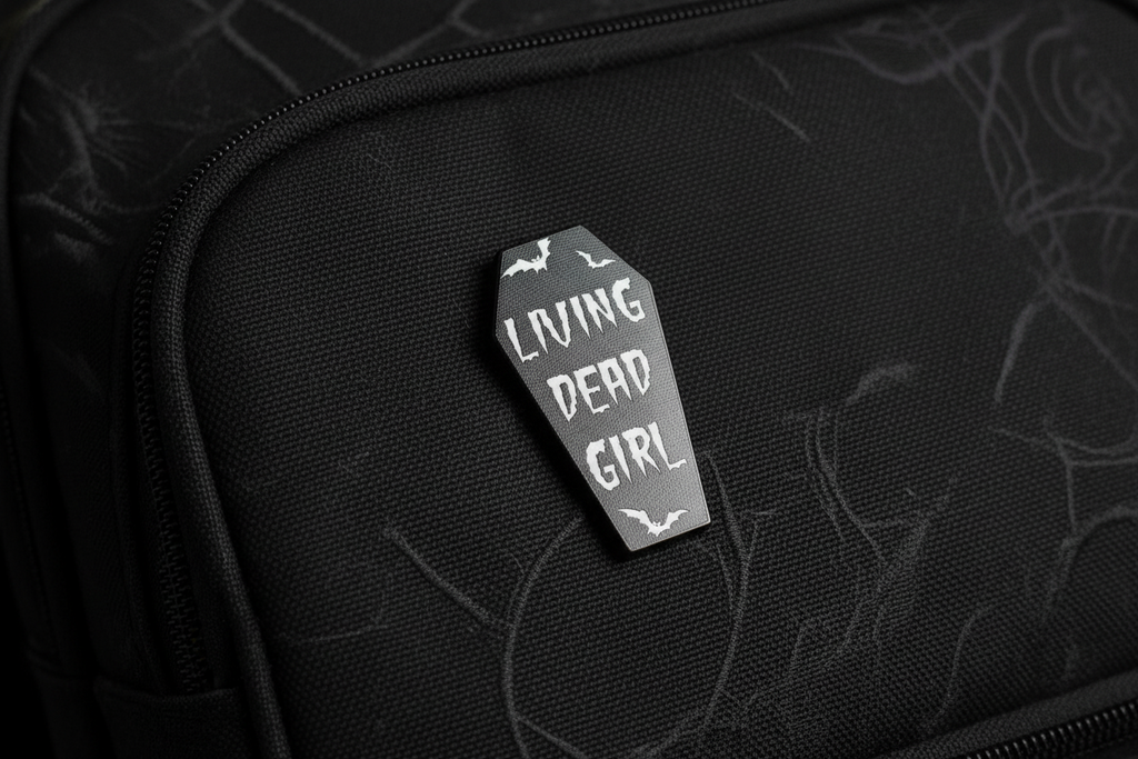 Living Dead Girl Enamel Pin on backpack witchy accessory for customizing bags and school gear