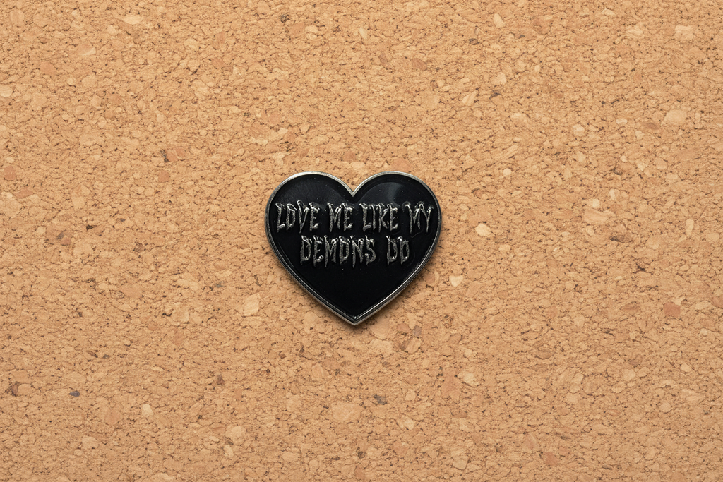 Love Me Like My Demons Do Enamel Pin displayed on cork board emo enamel pin for collectors and display