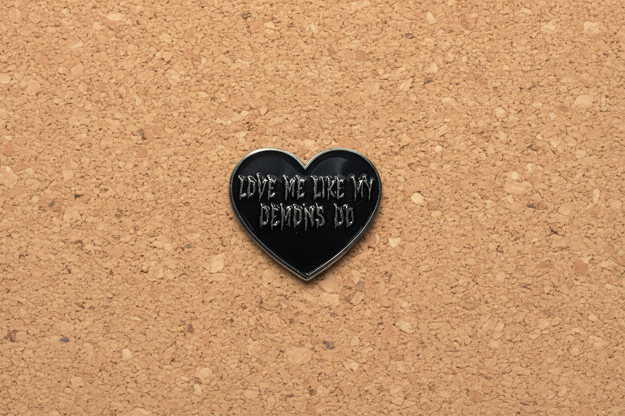 Love Me Like My Demons Do Enamel Pin displayed on cork board emo enamel pin for collectors and display