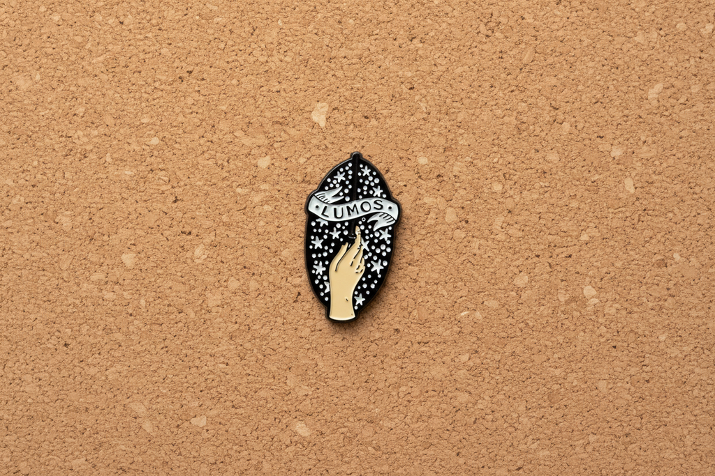 Lumos Enamel Pin displayed on cork board witch enamel pin for collectors and display