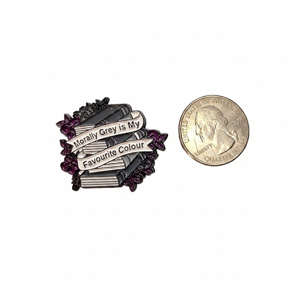 Morally grey enamel pin shown next to quarter for size reference funny enamel pin dims 1 1/2 In W x 1 In H
