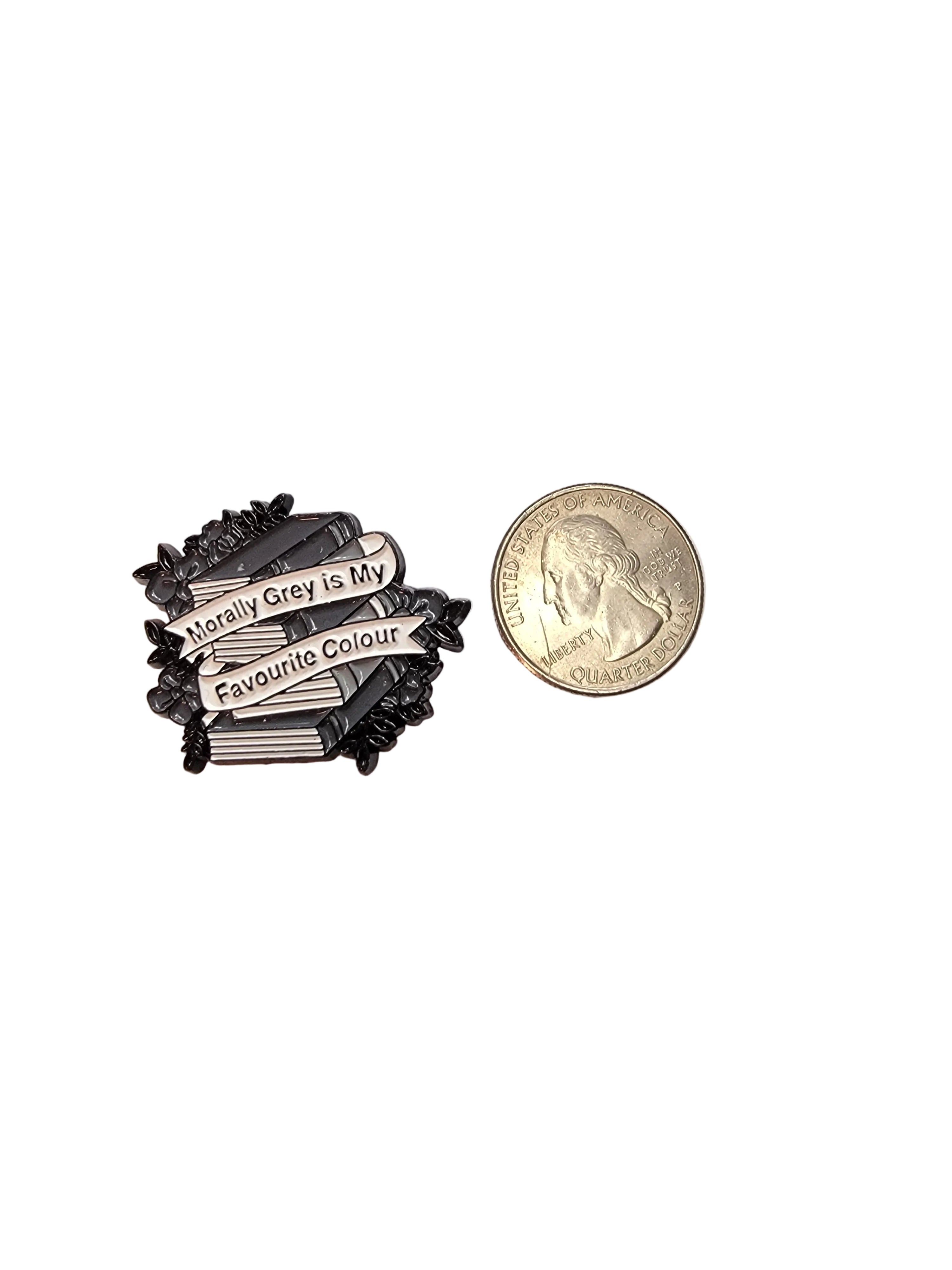 Small decorative item with text next to a quarter on a light background