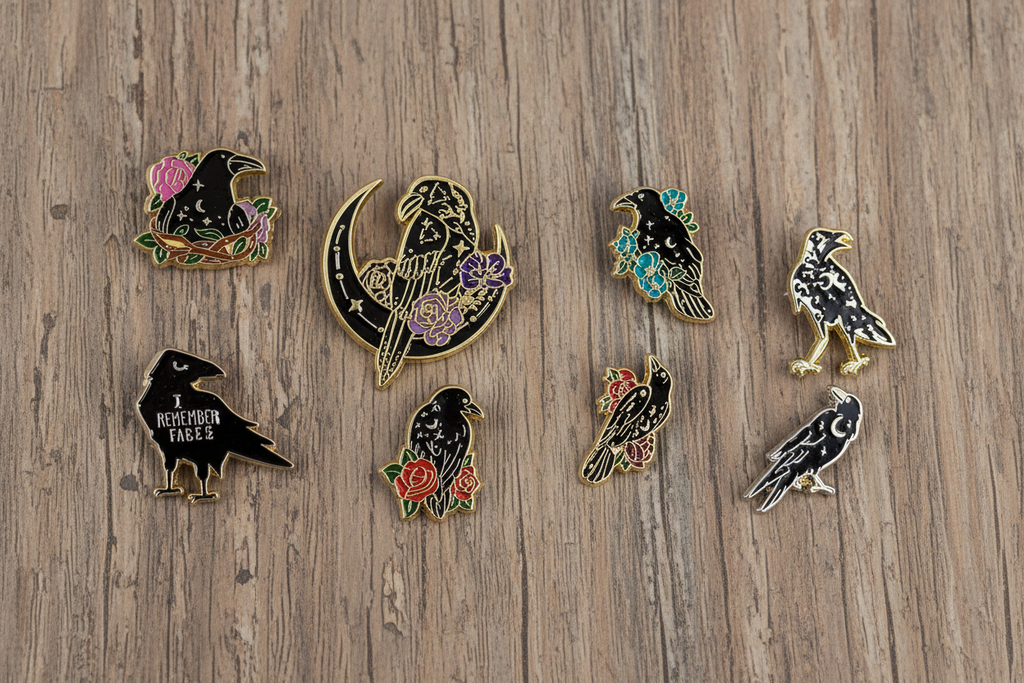 Mystical Crow Enamel Pin Collection on wood background witchy enamel pin with eight different designs
