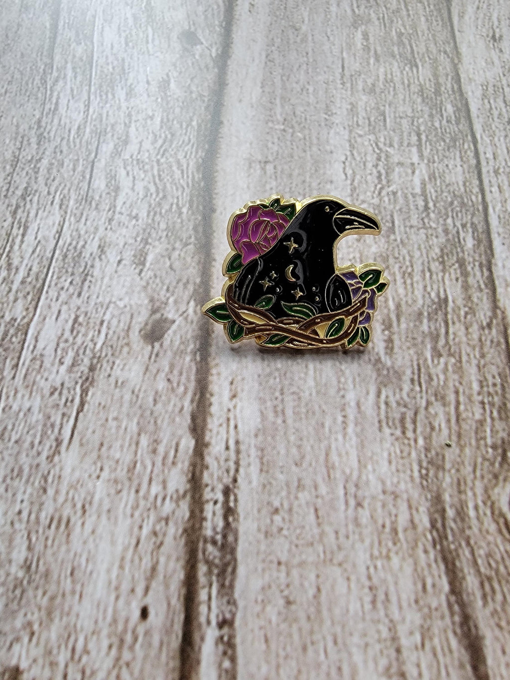 Mystical Enamel Pin on wood background witchy enamel pin with raven in a nest detail