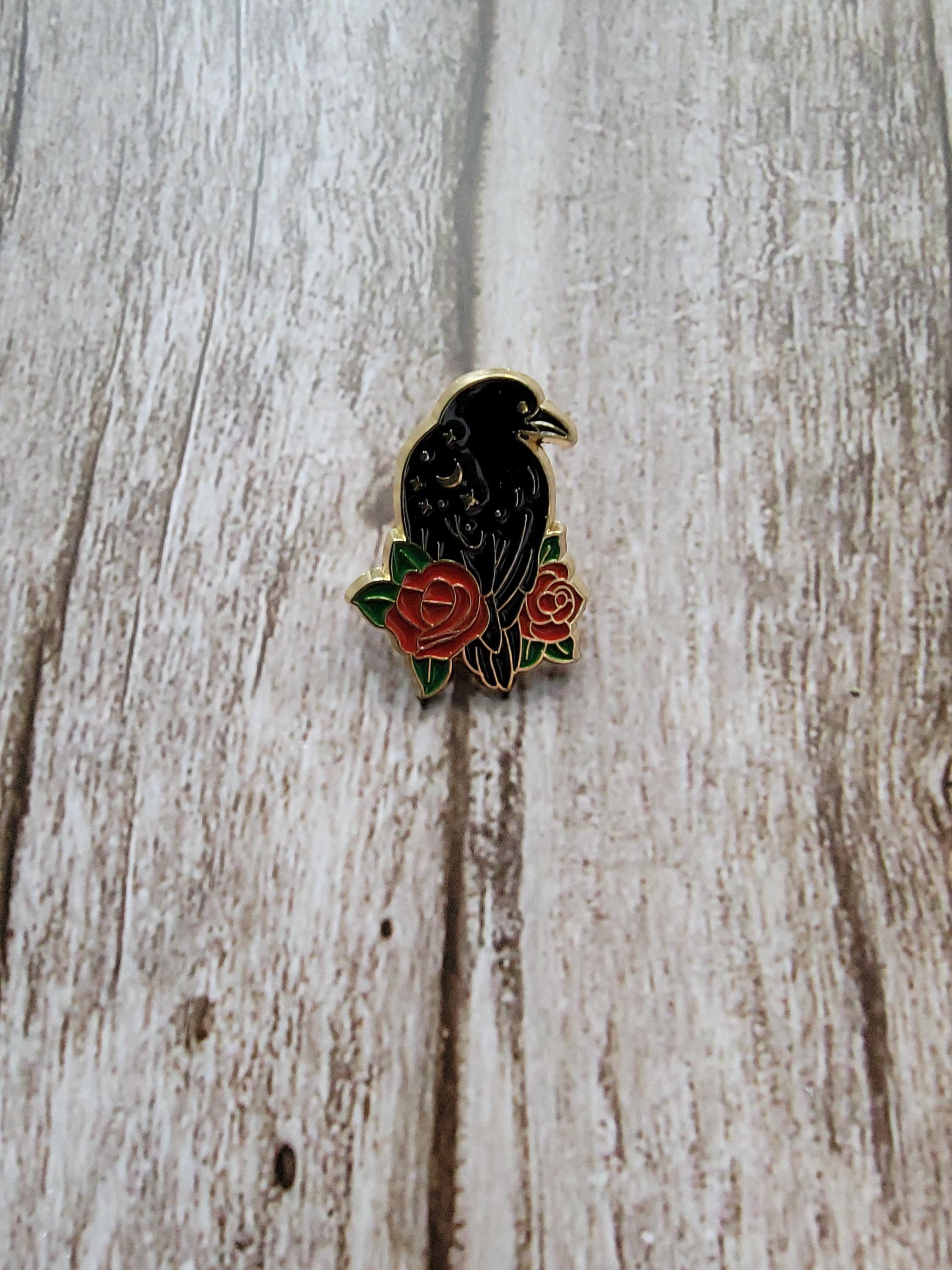 Mystical Crow Enamel Pin on wood background witch enamel pin with raven with red flowers detail