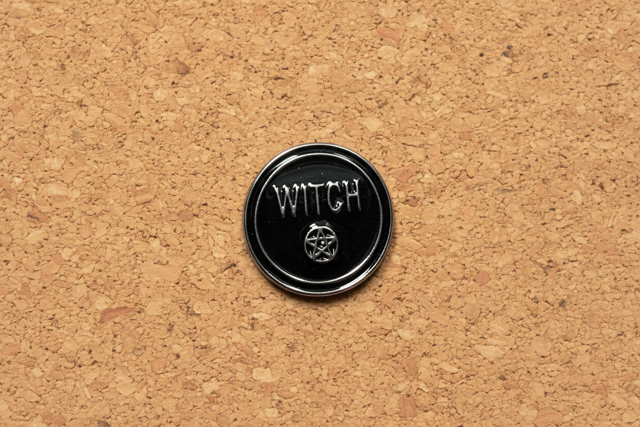 Round Witch Enamel Pin displayed on cork board goth enamel pin for collectors and display