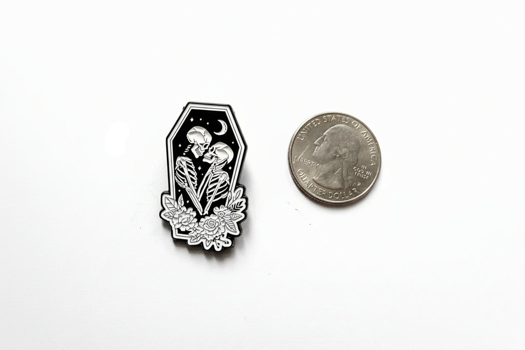 Skeleton lovers enamel pin shown next to quarter for size reference alt enamel pin  7/8 in W x 1 1/4 in H
