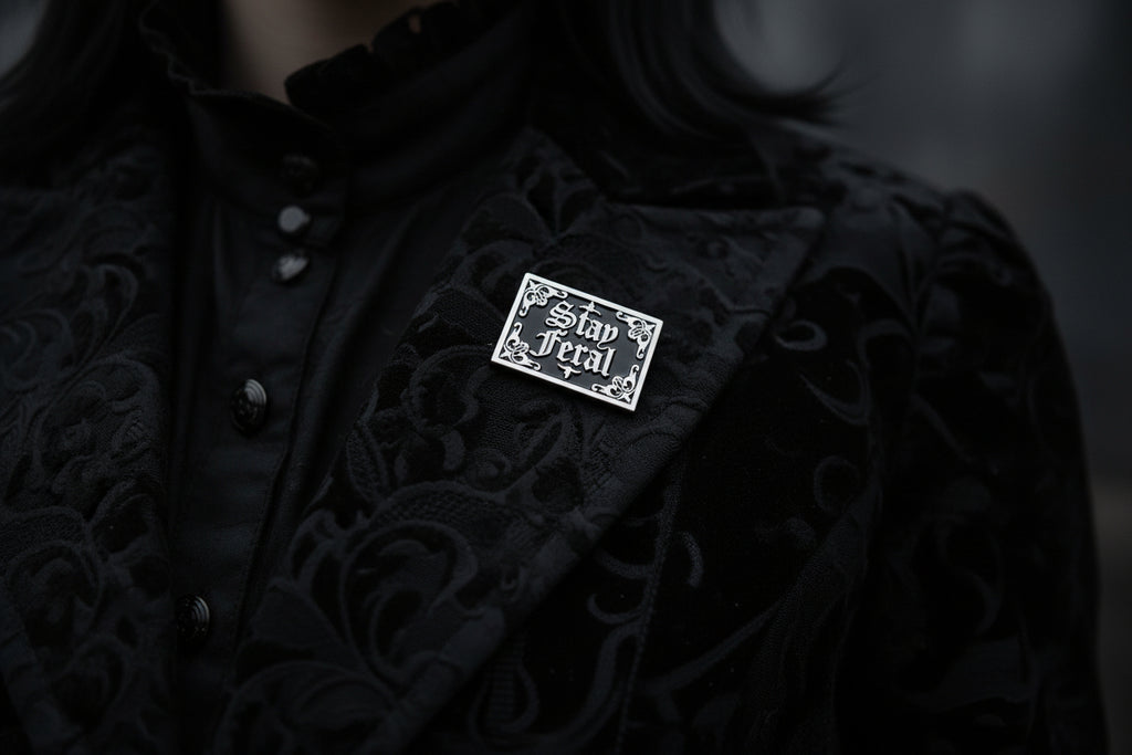 Stay Feral Enamel Pin worn on jacket lapel, gothic pin style for everyday wear