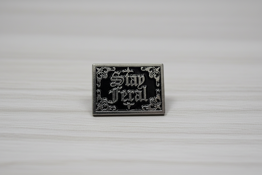 Stay Feral Enamel Pin on wood background gothic enamel pin with silver text detail