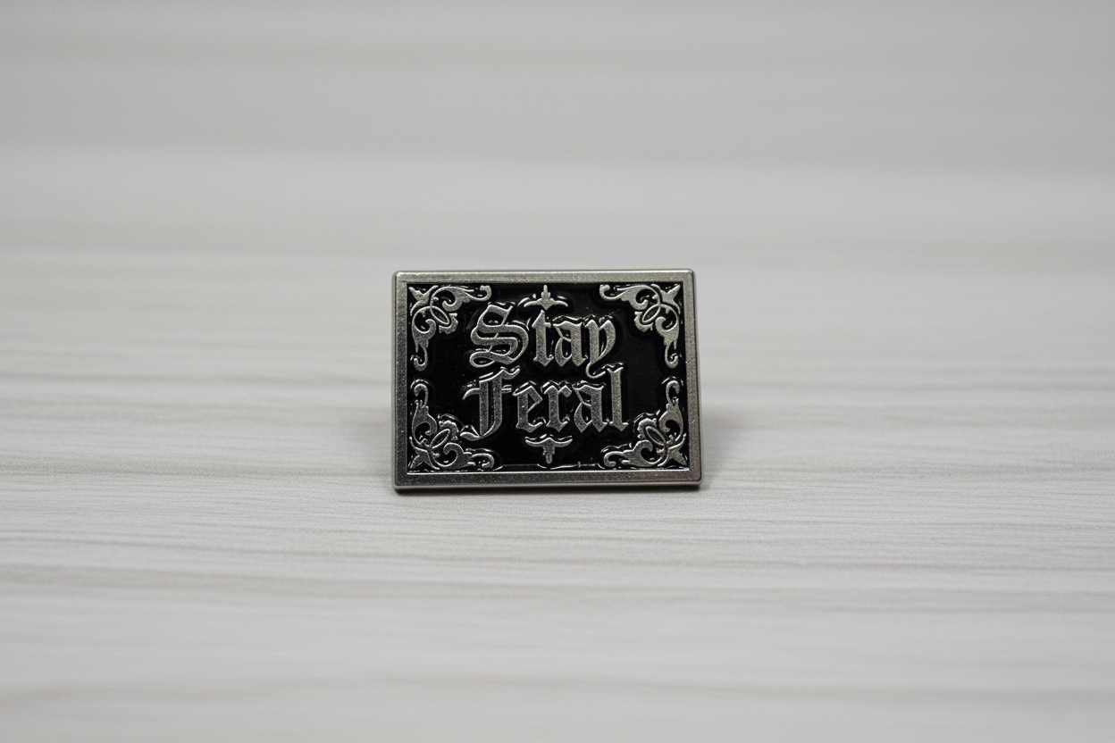 Stay Feral Enamel Pin on wood background gothic enamel pin with silver text detail