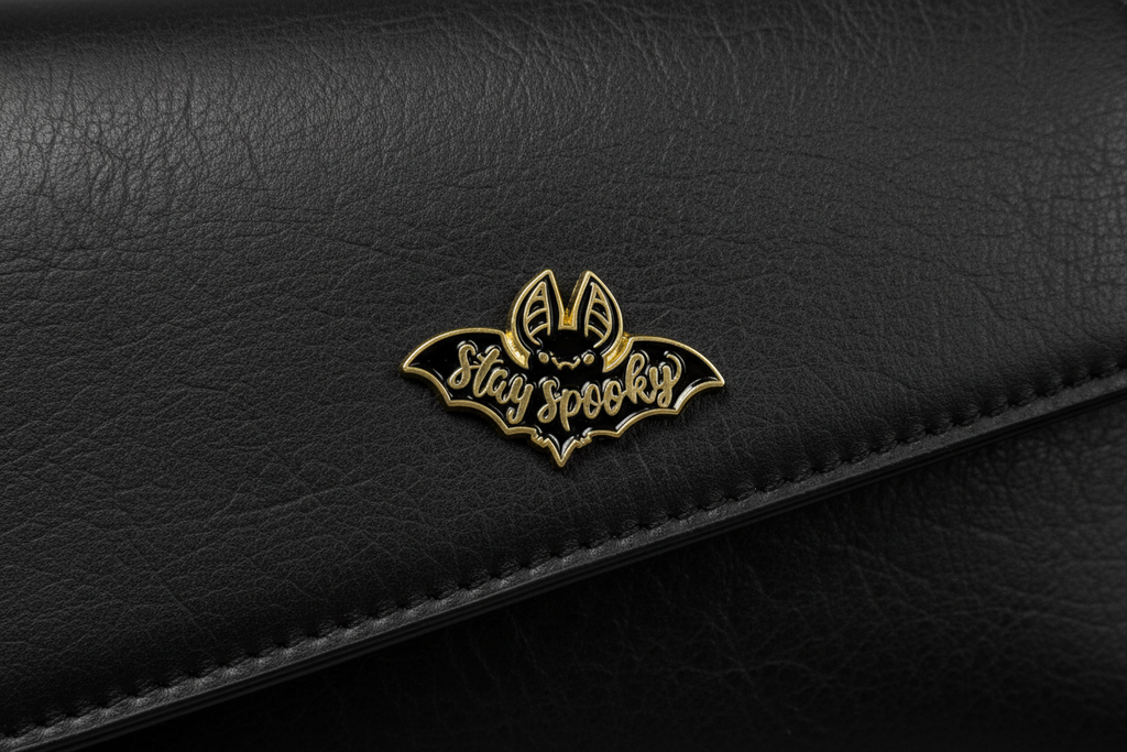 Stay Spooky Enamel Pin attached to purse Halloween brooch accessory for bags and personal style