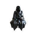 Black cloaked figure sitting down with a teacup on a white background