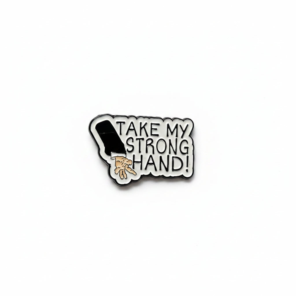 Pin with a design of a hand and text 'Take my strong hand' on a white background