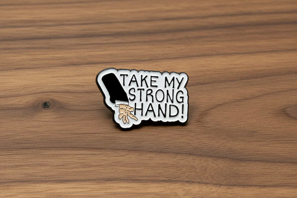 Pin with a design of a hand and text 'Take my strong hand' on a wooden background