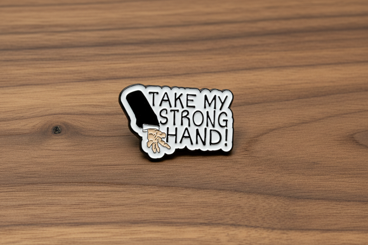 Pin with a design of a hand and text 'Take my strong hand' on a wooden background