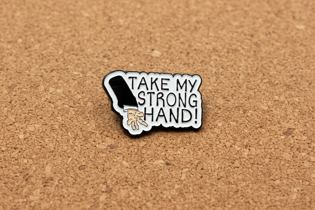 Pin with a design of a hand and text 'Take my strong hand' on a cork background