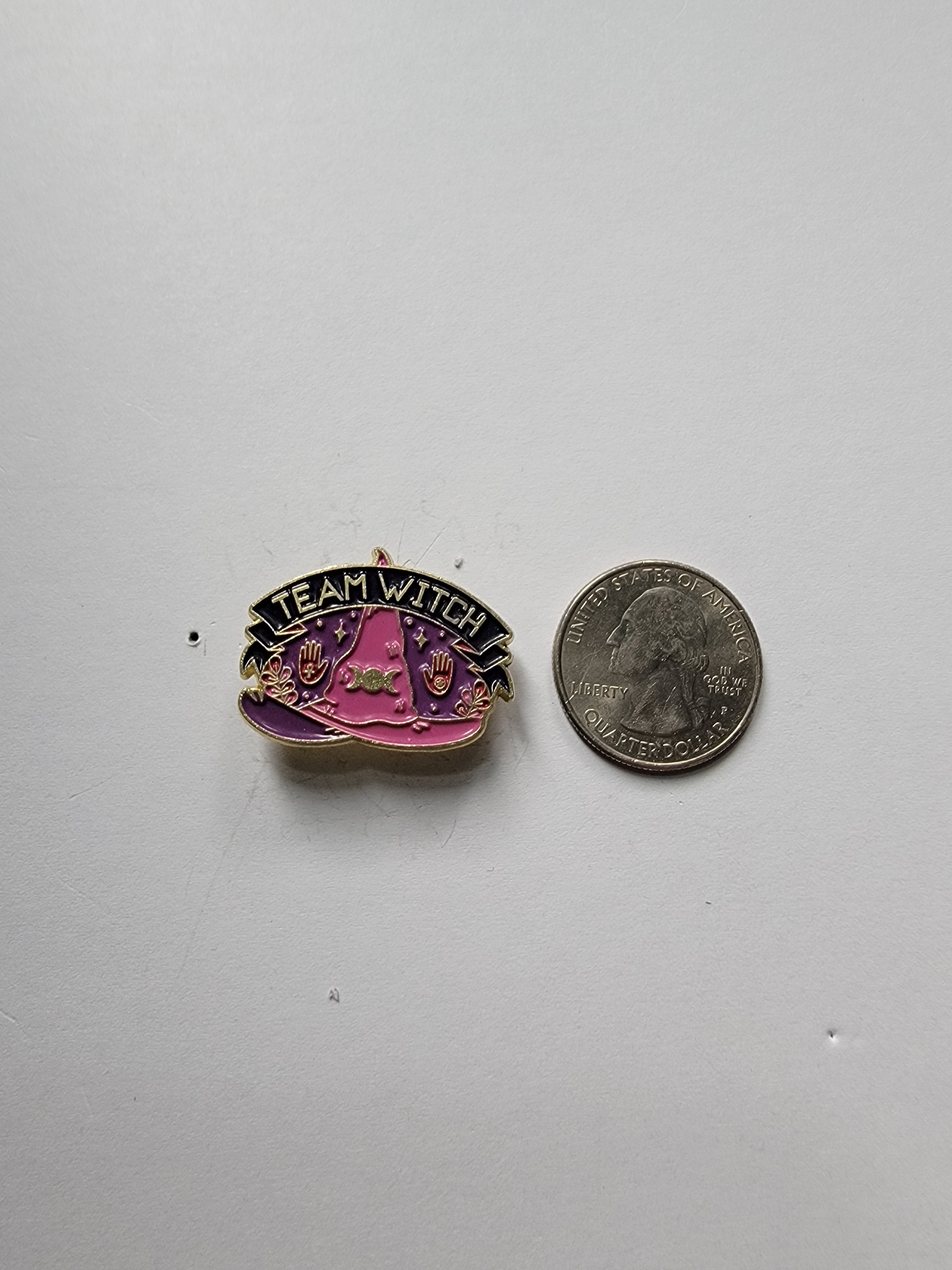 Team Witch Enamel Pin shown next to quarter for size reference pastel goth enamel pin dims 1 1/8 in W x 7/8 in H
