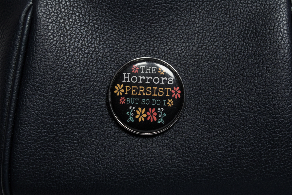 The Horrors Persist But So Do I Enamel Pin- Funny Meme Pin, Coworker Gift, Bookbag and Lapel Pin