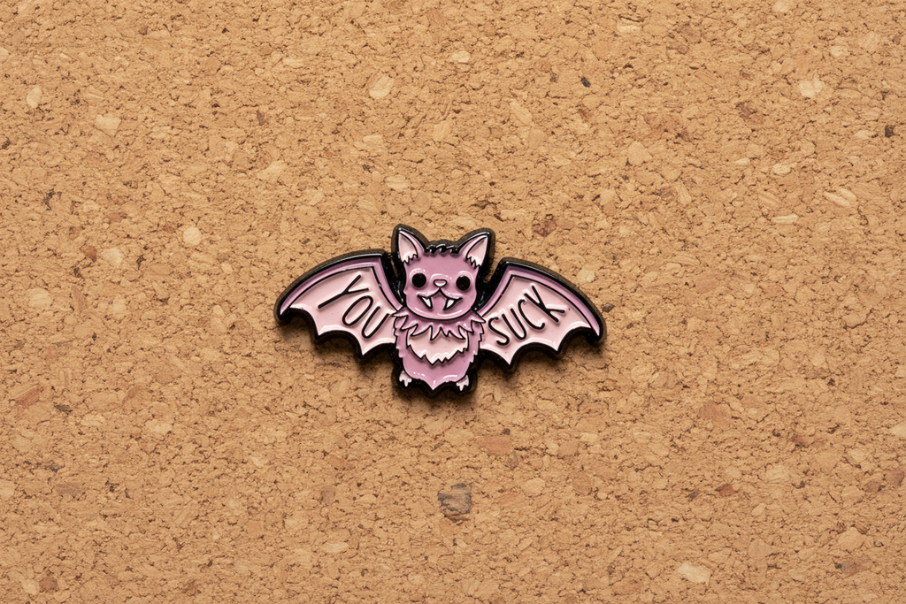 You Suck Enamel Pin displayed on cork board witchy enamel pin for collectors and display