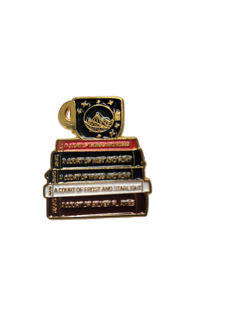 Set of decorative book-shaped pins on a white surface