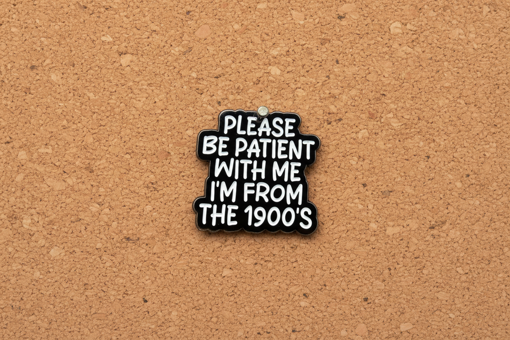 Black and white pin with text on a cork background