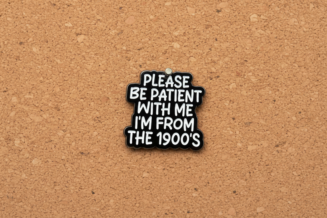 Black and white pin with text on a cork background