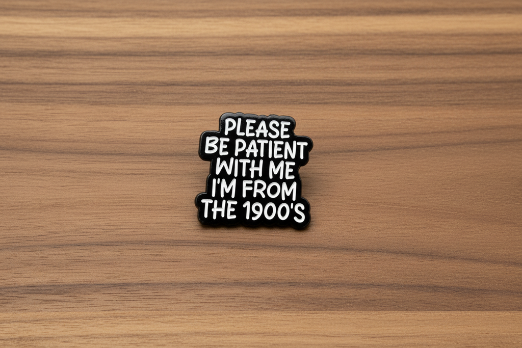 Black and white pin with text on a wooden background