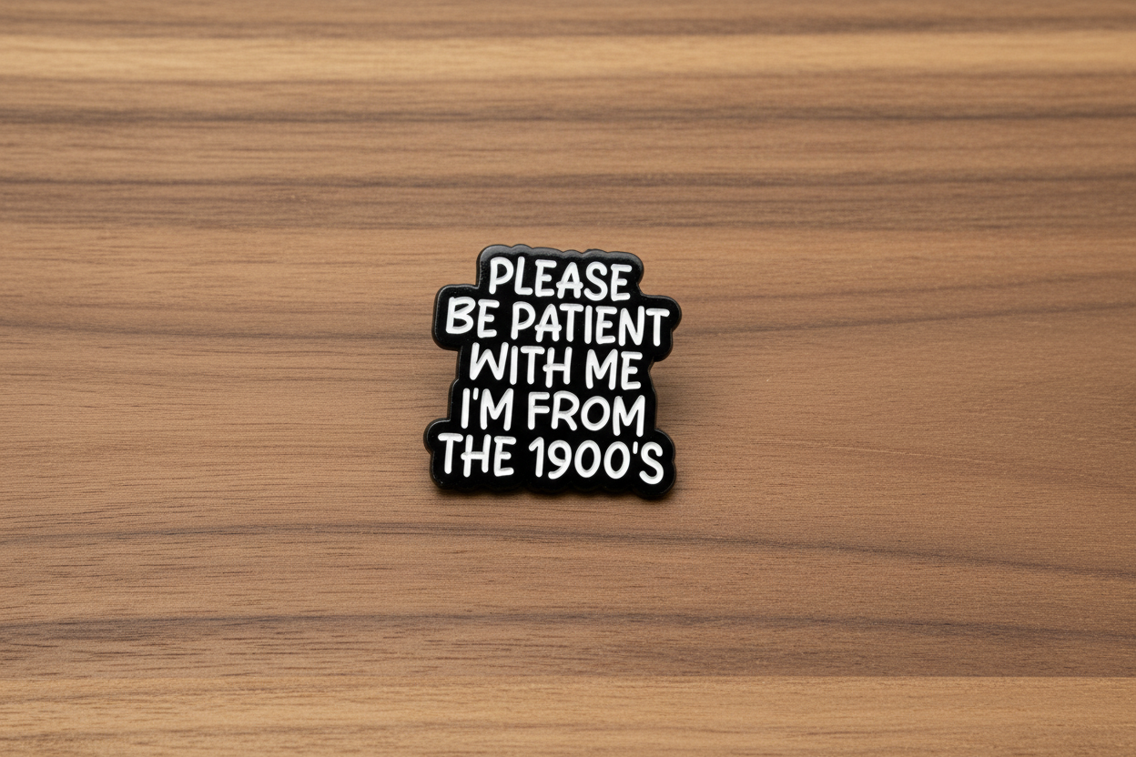 Black and white pin with text on a wooden background