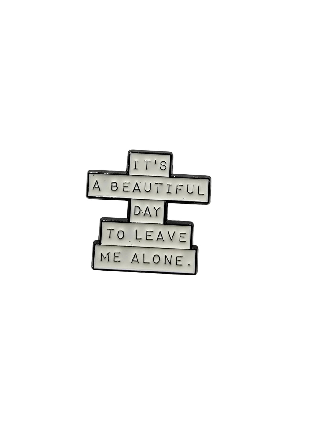 Metallic badge with text on a gray background