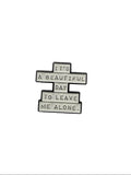 Metallic badge with text on a gray background