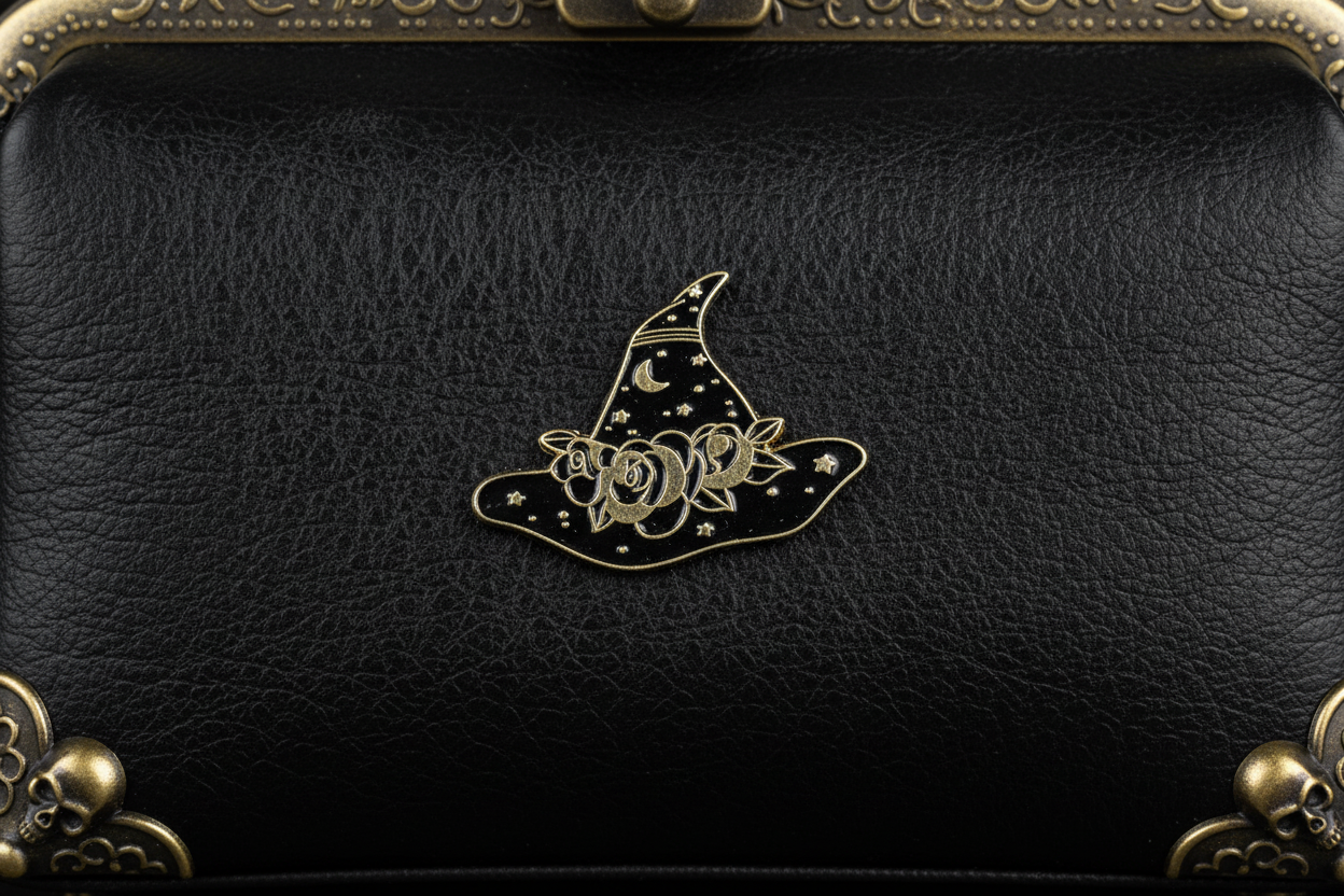black and gold enamel pin attached to purse witchy brooch accessory for bags and personal style