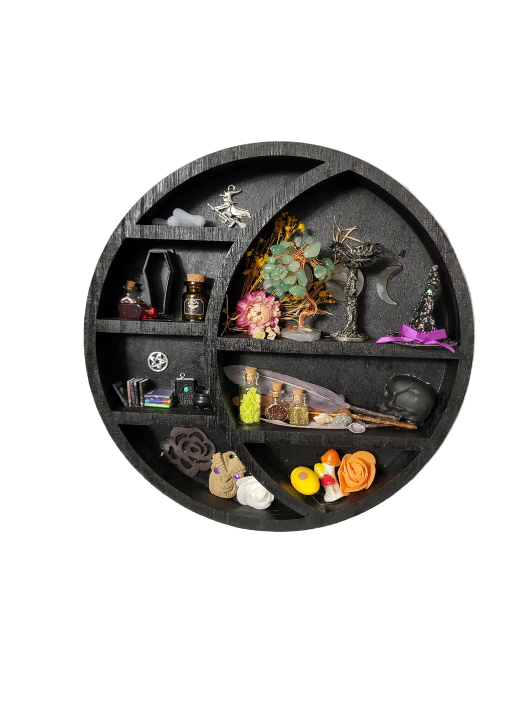 Round decorative shelf with various small items on a white wall