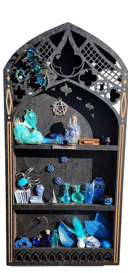 Decorative shelf with blue and green decorative items against a light blue wall.