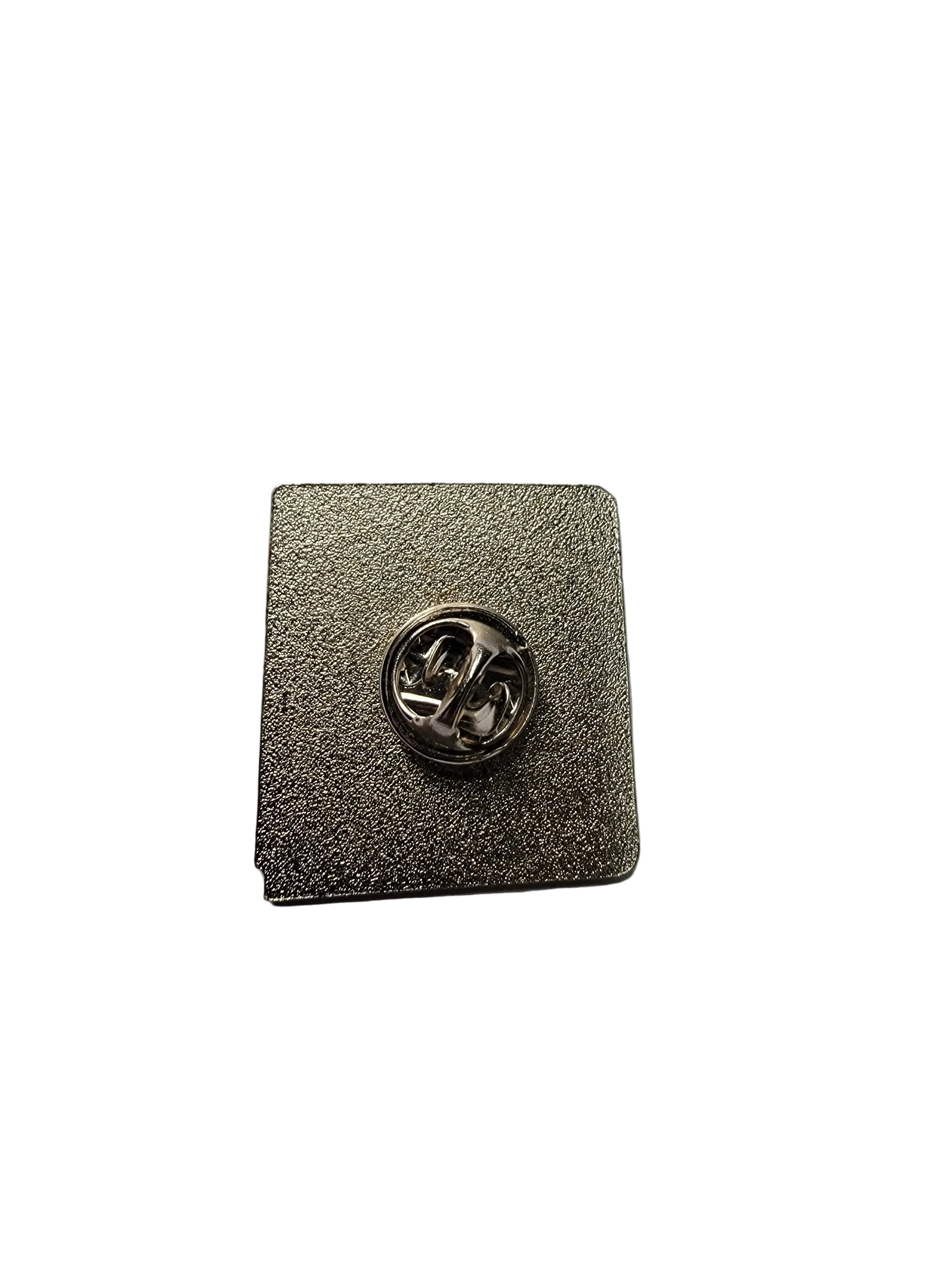 Metallic square pin with circular emblem on a gray background