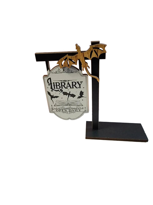 Decorative sign on a stand with 'Library Open Daily' text against a gradient background
