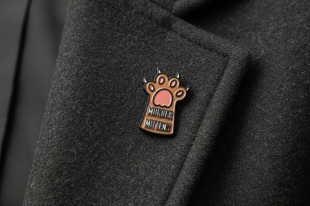 Small enamel pin with a paw design and text on a gray background