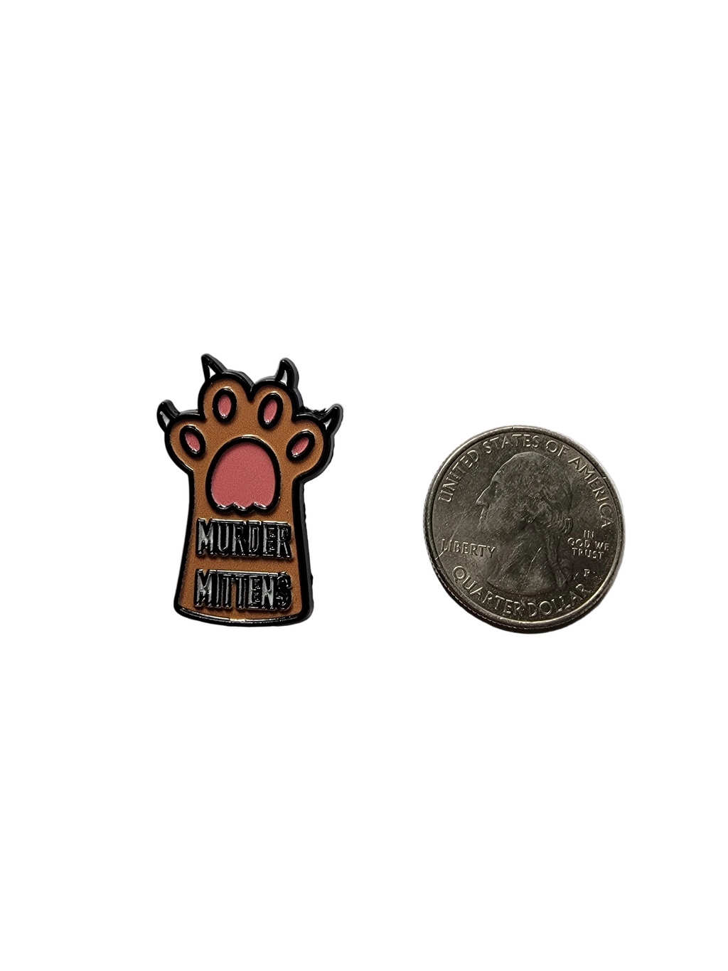Small metal pin with paw design and 'murder mittens' text on a white background, compared to a quarter for scale.