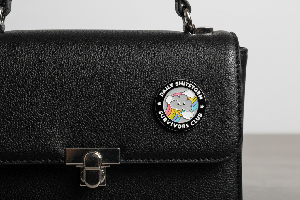 Round badge with a cartoon bear and text on a black background